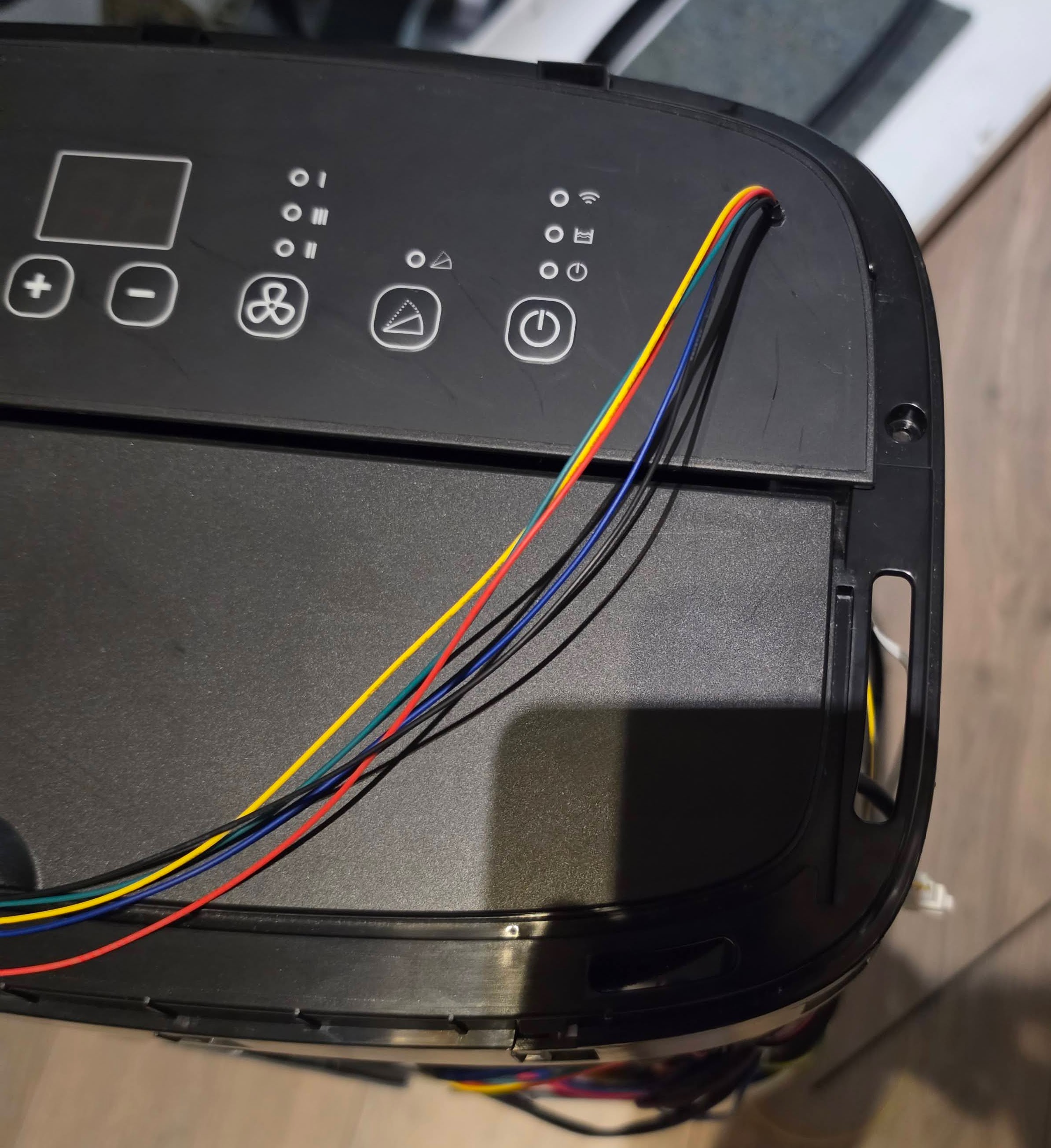 Cables routed through a hole drilled in the top of the AC