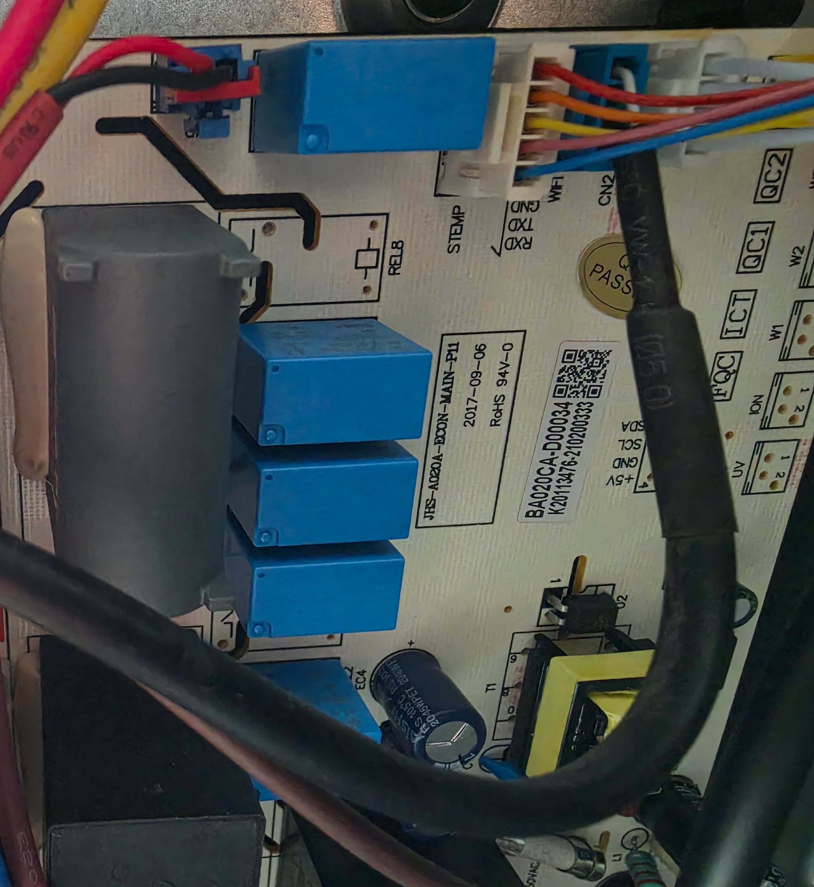 The main circuit board inside the AC labeled “JHS”